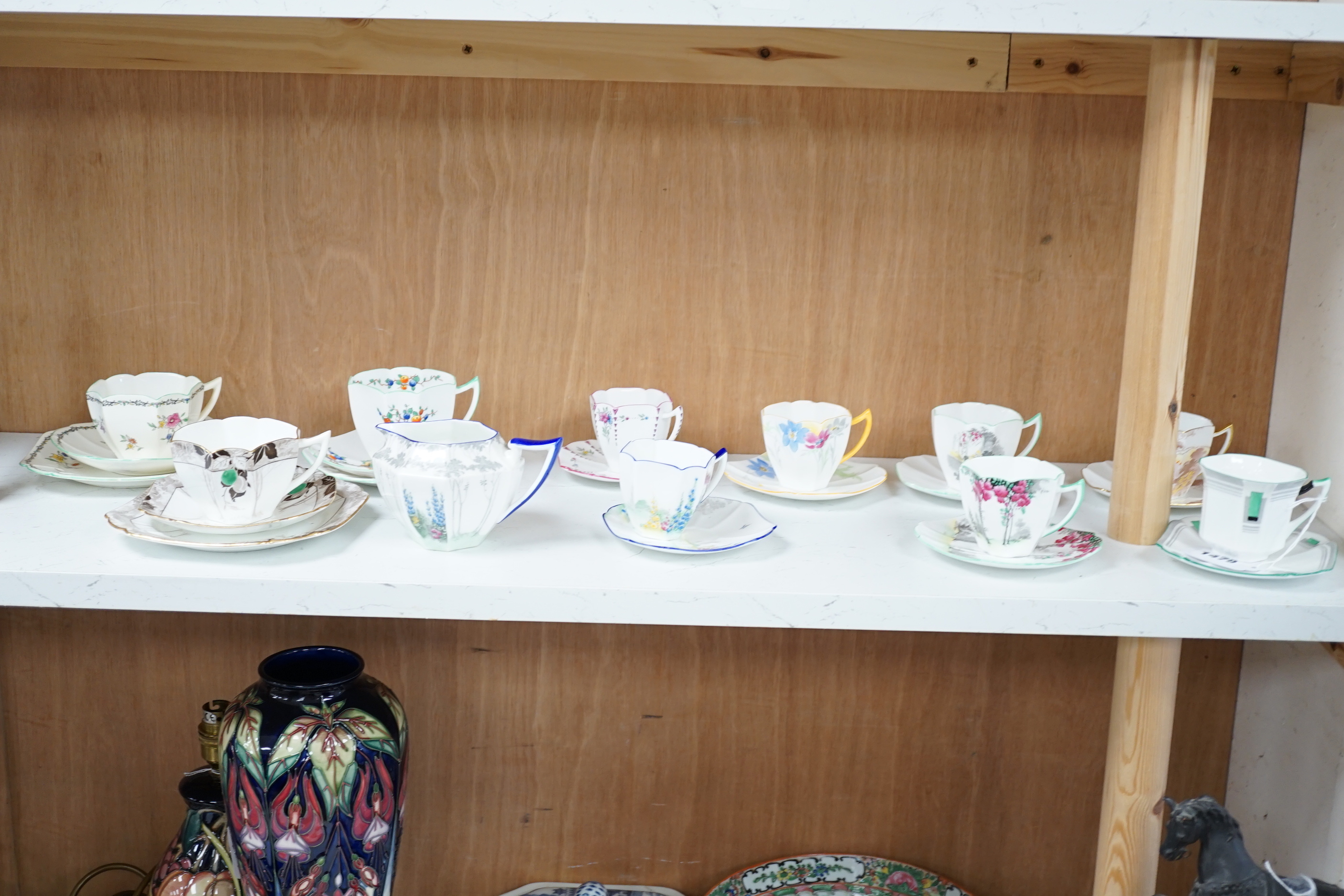 Seven Shelley Art Deco cups and saucers, three trios and a milk jug, some with Art Deco designs, largest 13cm wide